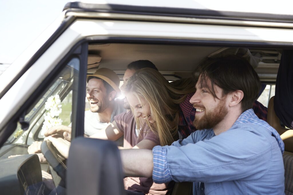 Happy friends in minivan