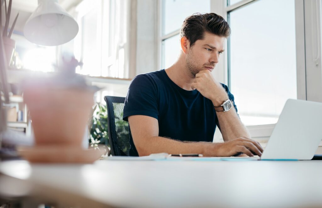 Handsome young man using laptop