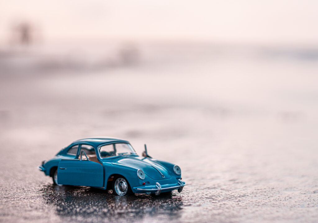 closeup-shot-of-a-blue-toy-car-on-the-water-in-day-2023-11-27-04-50-03-utc