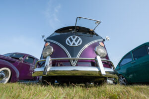 Fully restored purple split-screen Camper van at a meeting of classic vehicles in Rushmoor, UK – April 19, 2019