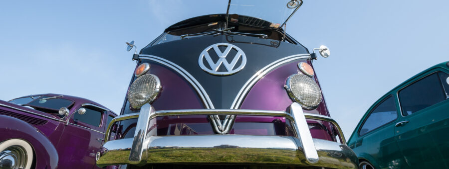 Fully restored purple split-screen Camper van at a meeting of classic vehicles in Rushmoor, UK – April 19, 2019