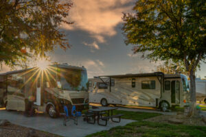 Sunburst above the motorhome camping in the morning at a campsite